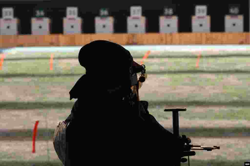 Mahlagha Jambozorg of Iran takes aim in the women&#39;s 50-meter rifle competition.