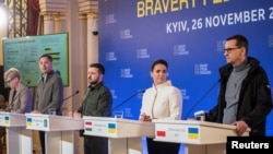 Lithuanian Prime Minister Ingrida Simonyte (left), Belgian Prime Minister Alexander De Croo (second from left), Ukrainian President Volodymyr Zelenskiy (center), Hungarian President Katalin Novak (second from right), and Polish Prime Minister Mateusz Morawiecki attend a joint news conference after an international summit in Kyiv on November 26. 