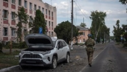 Un soldat ucrainean trece pe lângă o clădire avariată în Sudja, regiunea Kursk din Rusia (fotografie de arhivă).