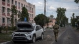  A Ukrainian soldier walks past a damaged building in Sudzha in Russia's Kursk region. (file photo)