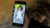 Mariam Soumah shows a photo on her phone of her daughter Sabina at her home in Conakry, on December 29, 2025.