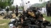 Villagers and officials collect the shoes of participants in the funeral ceremony of an anti-Taliban leader who was targeted in a suicide bombing in Lower Dir in September 2011. (file photo)