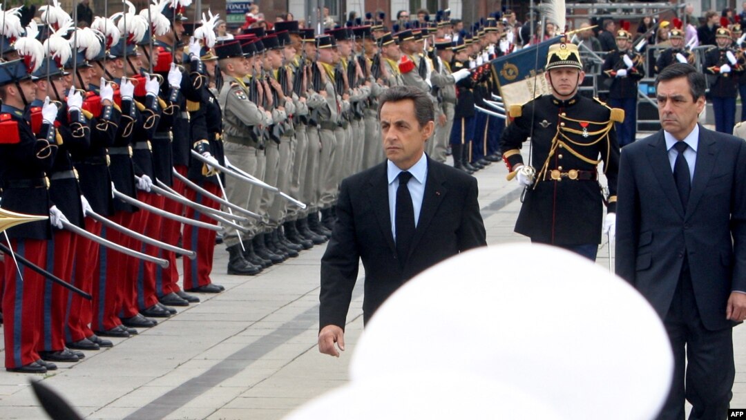 French President Nicolas Sarkozy (center) and Prime Minister Francois Fillon (right) take part in a ceremony marking the 65th anniversary of the Allied victory over Nazi Germany in World War II in Colmar, in eastern France.