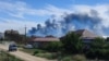 Smoke rises after explosions were heard at an air base near Novofedorivka in Crimea on August 9. 