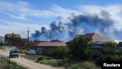 Smoke rises after explosions were heard at an air base near Novofedorivka in Crimea on August 9. 