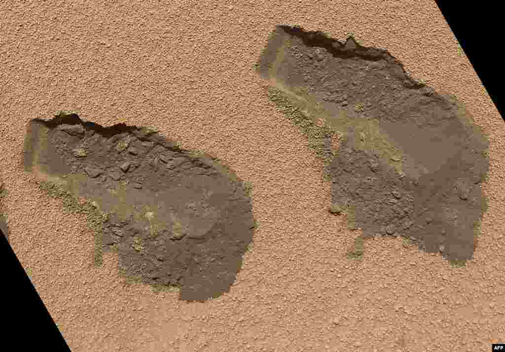 This picture shows a view of the third and fourth trenches made by a scoop on NASA&#39;s Mars rover &quot;Curiosity&quot; in October 2012. The image, just released by NASA, was taken on October 31 and shows some of the details regarding the properties of the planet&#39;s wind drift sand. (AFP/NASA)