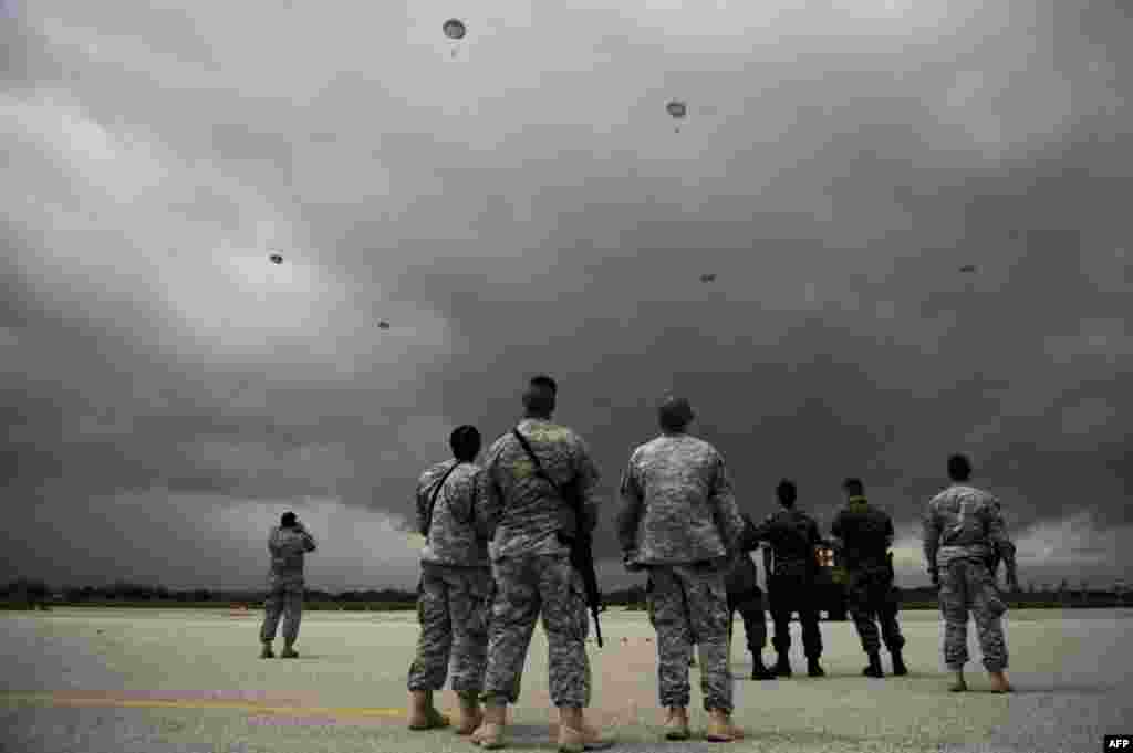 U.S. Army soldiers, part of the NATO-led peacekeeping mission in Kosovo, jump with parachutes during a military drill near the town of Gjakova. (AFP/Armend Nimani)
