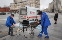 Paramedics take an elderly woman to the hospital durinig the coronavirus lockdown in central Moscow.