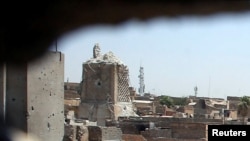 A destroyed minaret at the Grand Al-Nuri Mosque is pictured through a hole at an Iraqi-held position in the Old City in Mosul on June 27.