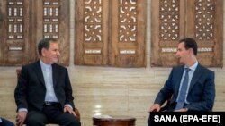 Syrian President Bashar Assad (R) meets with Iranian First Vice-President Eshaq Jahangiri in Damascus, January 29, 2019