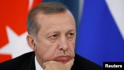 Turkish President Recep Tayyip Erdogan attends a news conference with Russian President Vladimir Putin (not seen) following their meeting in St. Petersburg on August 9.