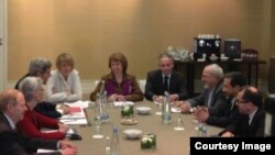 EU foreign policy chief Catherine Ashton (center) meets U.S. Secretary of State John Kerry (third from left) and Iran Foreign Minister Mohammad Javad Zarif (third from right) on November 9.