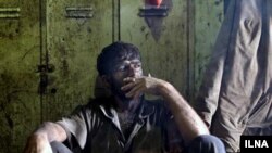 Iran - A Miner is smoking after his working shift.