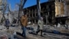 People walk past a children's hospital that was damaged by shelling in the Russian-controlled city of Donetsk, Ukraine, on March 9.