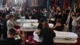 Mourners gather around the coffins of a mother and her three daughters who all died in a Russian missile strike in Lviv on September 4. Only the father survived.