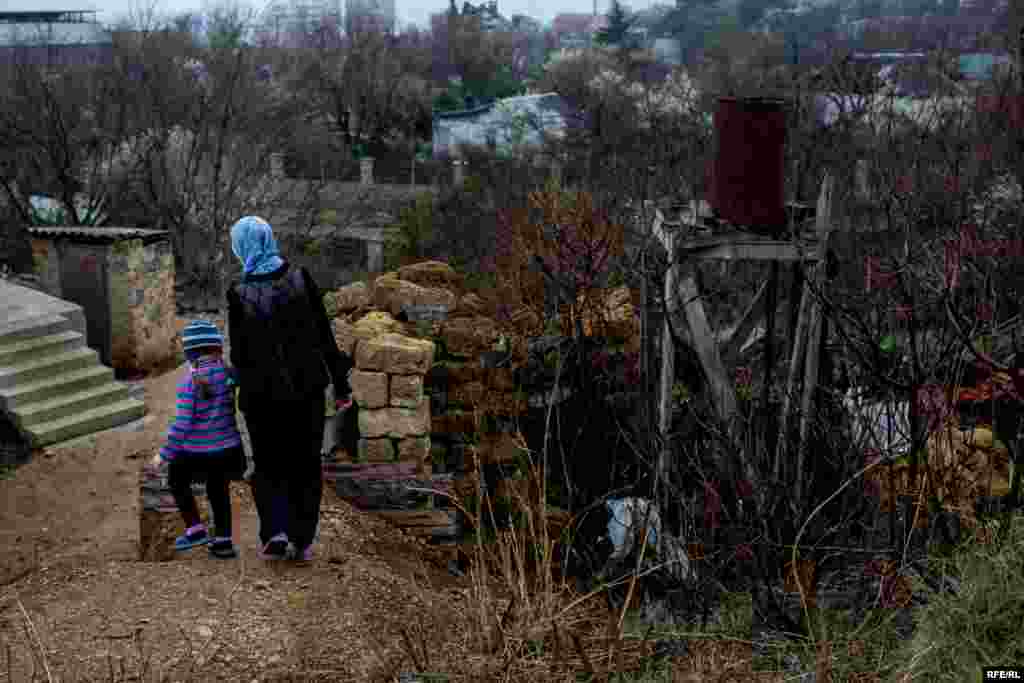 Miriem and Sofie walk outside their home.