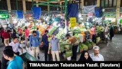 File photo - People buy vegetables and fruits at the Tajrish Bazaar in northern part of Tehran, Iran, August 2, 2017, before US sanctions led to hyper-inflation. 