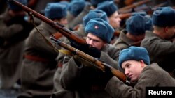 Participants dressed in historical uniforms perform during a military parade marking the anniversary of the 1941 parade when Soviet soldiers marched toward the front lines of World War II, in Red Square in Moscow on November 7.