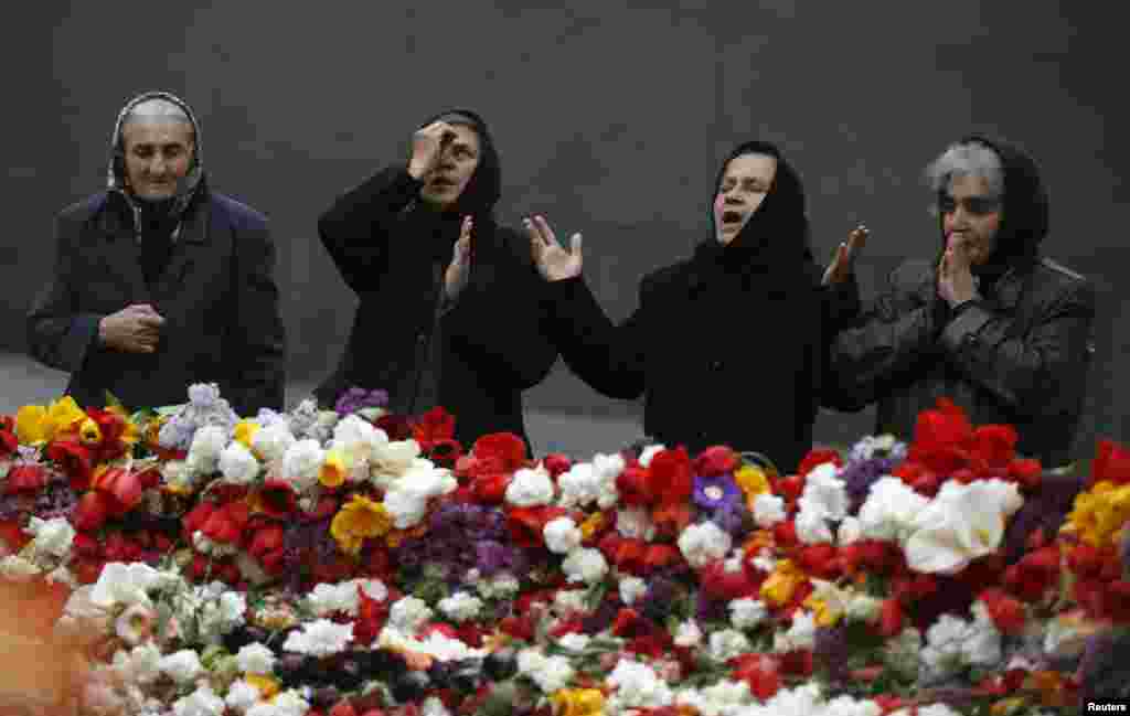 People mourn at the Tsitsernakaberd Armenian Genocide Memorial Museum in Yerevan on April 21. (Reuters/David Mdzinashvili)