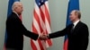 Then-Russian Prime Minister Vladimir Putin (right) shakes hands with then-U.S. Vice President Joe Biden during a meeting in Moscow in 2011.