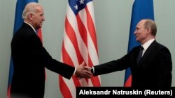 Then-Russian Prime Minister Vladimir Putin (right) shakes hands with then-U.S. Vice President Joe Biden during a meeting in Moscow in 2011.