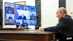 În această fotografie de arhivă distribuită de agenția de stat Sputnik, președintele Rusiei, Vladimir Putin, prezidează o ședință cu membrii guvernului prin videoconferință, la Moscova, pe 23 aprilie 2026.