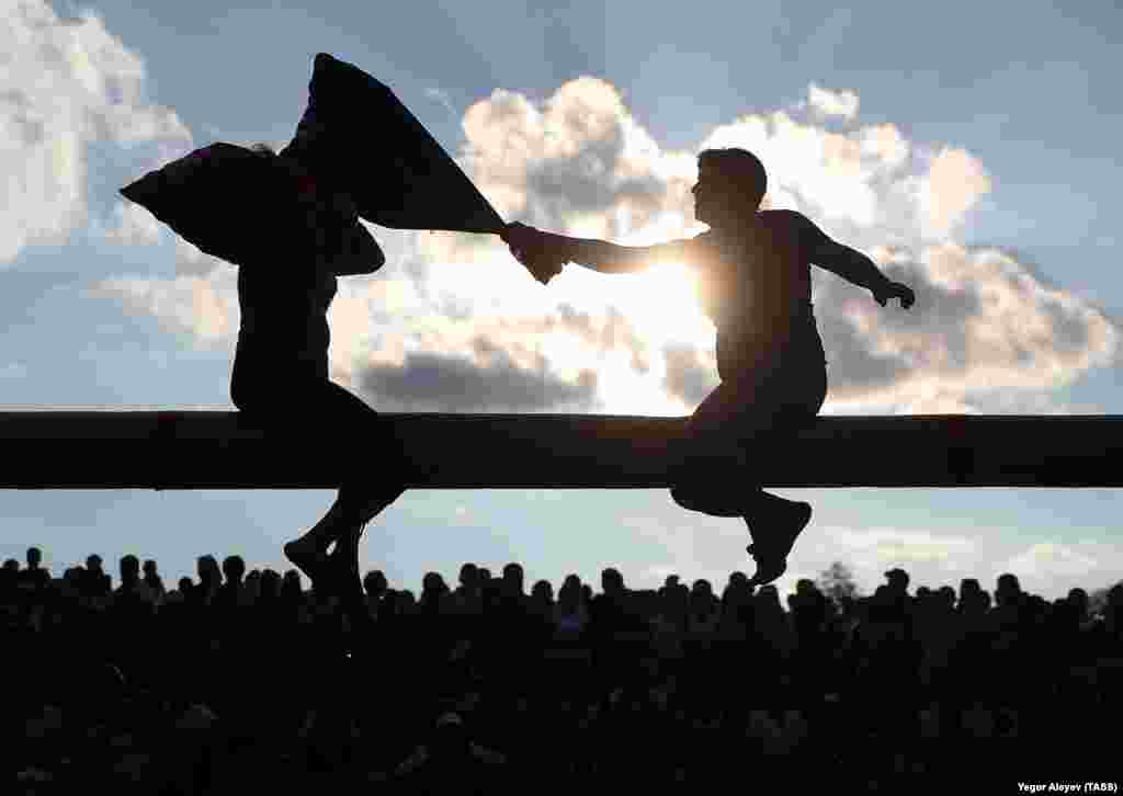 Two men take part in a &quot;sack battle&quot; during the Tatar national holiday of Sabantuy in the village of Minger in Russia&#39;s Sabinsky District. (Yegor Aliyev/TASS)