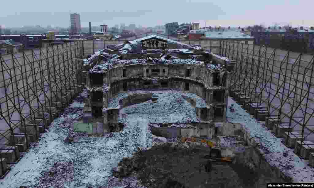 A section of the theater’s ruins in February 2023, after it was fenced off, and reconstruction work had begun in the Russian-held Ukrainian city. Locals allege the bodies of many killed in the Russian strike were entombed under the building as it was rebuilt.