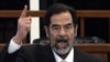 Saddam Hussein reacts as the court pronounces him guilty on November 5