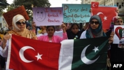 Pakistani students of the private PakTurk International Schools and Colleges hold placards during a protest in Karachi on November 18.