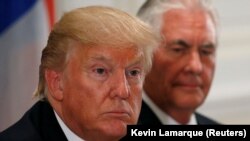 U.S. President Donald Trump and U.S. Secretary of State Rex Tillerson (R) attend a working dinner with Latin American leaders in New York, U.S., September 18, 2017