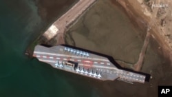 Iran's refurbished mockup aircraft carrier, used previously as a simulated U.S. target during a February 2015 naval exercise, is seen at its home port of Bandar Abbas in February.
