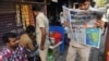 An auto-rickshaw driver reads a newspaper with front-page reports on the Indian air strikes against purported militant camps in Pakistan's territory, in Mumbai, on February 27.