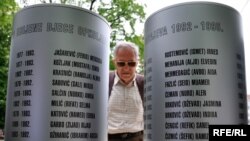 A man reads names on a monument to children who fall victim to the four-year siege of Sarajevo (1992-1995).