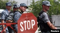 Police officers at a checkpoint near the border of the province of Ingushetia where a suicide bomber blew himself up (file photo)