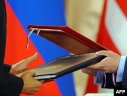 U.S. President Barack Obama and his Russian counterpart, Dmitry Medvedev, exchange the signed New START Treaty in Prague in April 2010.