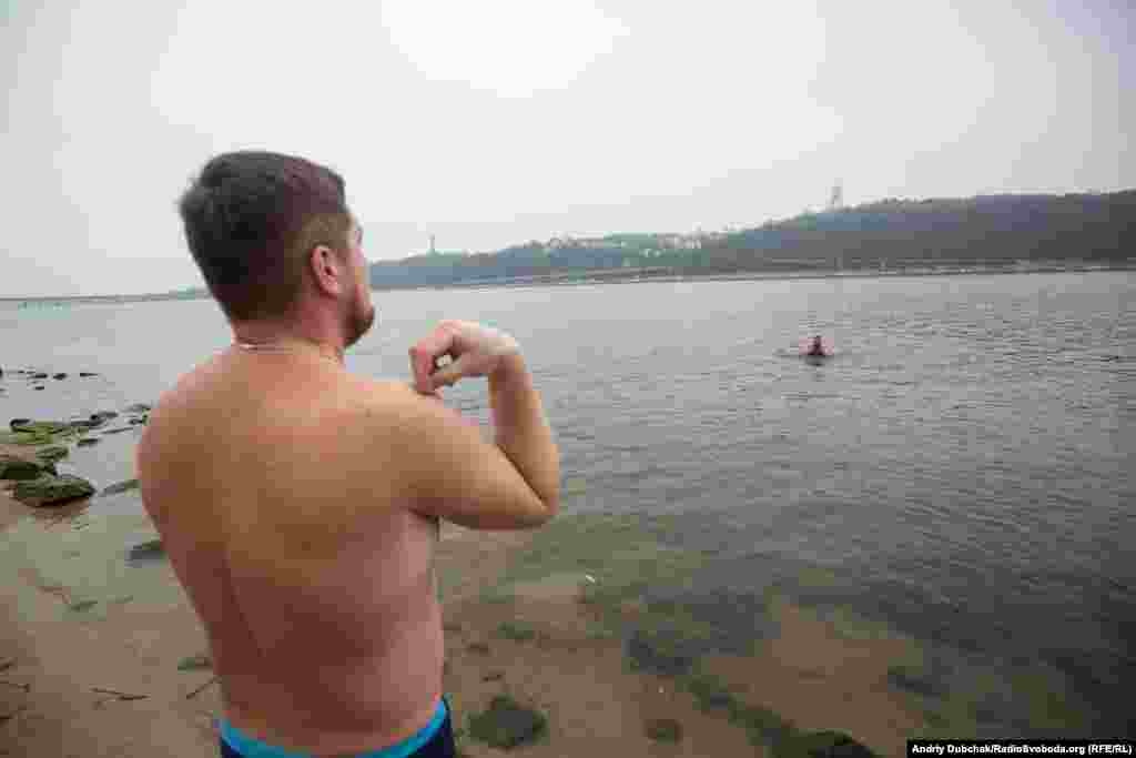 An Orthodox believer on the banks of the Dnieper River. The faithful believe that plunging into the icy waters during Epiphany strengthens their spirit and body.&nbsp;