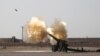 Iraqi forces fire artillery toward Islamic State militants near Fallujah on June 1.