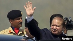 Pakistani Prime Minister Nawaz Sharif waves after attending the Pakistan Day parade in Islamabad on March 23.