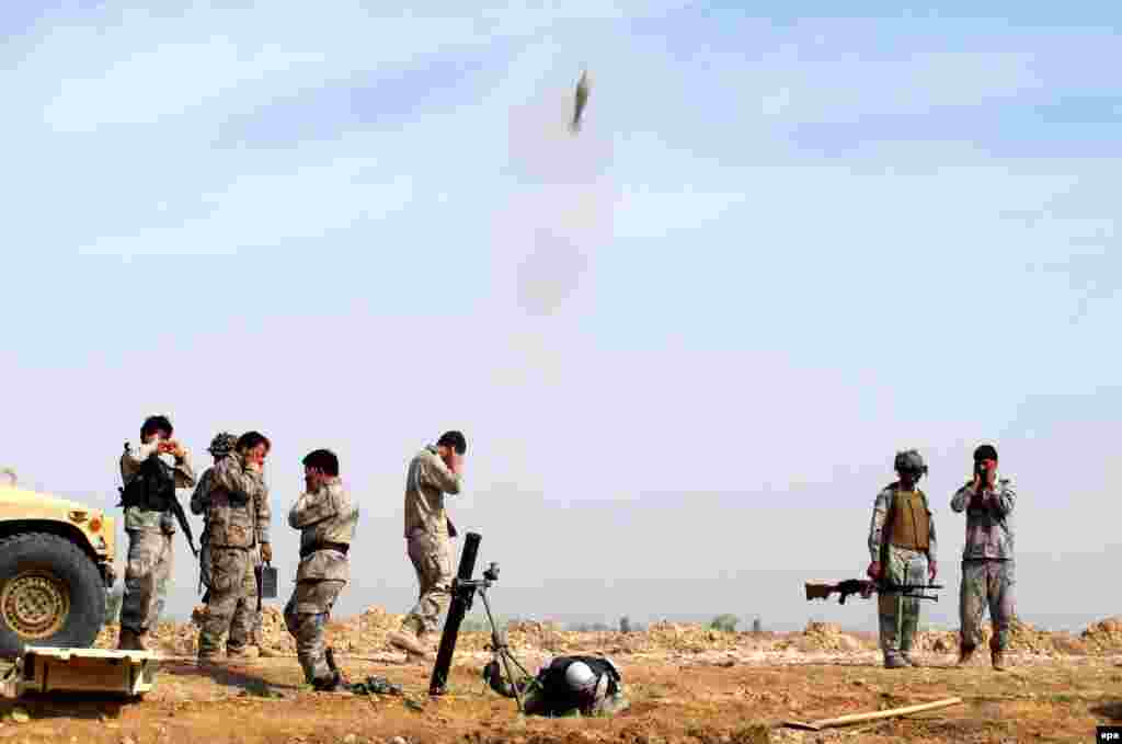 Afghan Border Police fire a missile against suspected Taliban hideouts during an operation in the Marjah district of Helmand Province on February 18. (epa/Watan Yar)