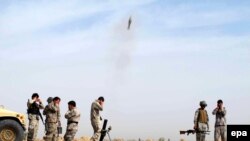 File photo of Afghan border Police fire a missile against suspected Taliban hideouts in Helmand.