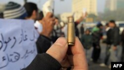 Egypt -- A protester shows a spent bullet casing during a demonstration onTahrir Square in Cairo, 19Dec2011