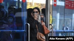 File photo: IRAN -- Iranians wear masks to help guard against dangerous levels of air pollution as they walk in the centre of the smog-filled capital Tehran, November 13, 2019