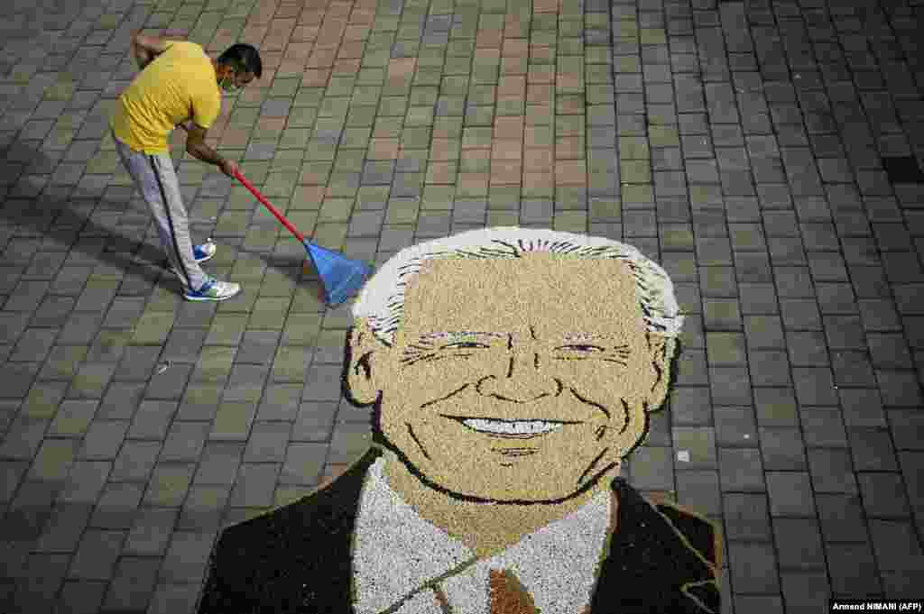 Kosovar artist Alkent Pozhegu works on the final touches of an image made with grain and seed, depicting Joe Biden, the U.S. Democratic presidential nominee, in the town of Gjakova. (AFP/Armend Nimani)