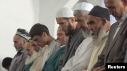 Men attend Friday prayers at the office of the Islamic Renaissance Party in Dushanbe in September 2010