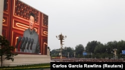 Chinese President Xi Jinping is seen on a giant screen as he delivers a speech marking the 100th anniversary of the Communist Party of China, on Tiananmen Square in Beijing on July 1.