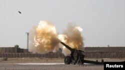 Iraqi forces fire artillery toward Islamic State militants near Fallujah on June 1.