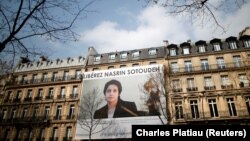 A banner with a giant portrait of jailed Iranian lawyer Nasrin Sotoudeh is seen on the headquarters of the French National Bar Council, demanding her release, in Paris, March 28, 2019