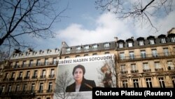 FRANCE -- A banner with a giant portrait of jailed Iranian lawyer Nasrin Sotoudeh by Arash Ashourinia is seen on the headquarters of the French National Bar Council, demanding her release, in Paris, March 28, 2019