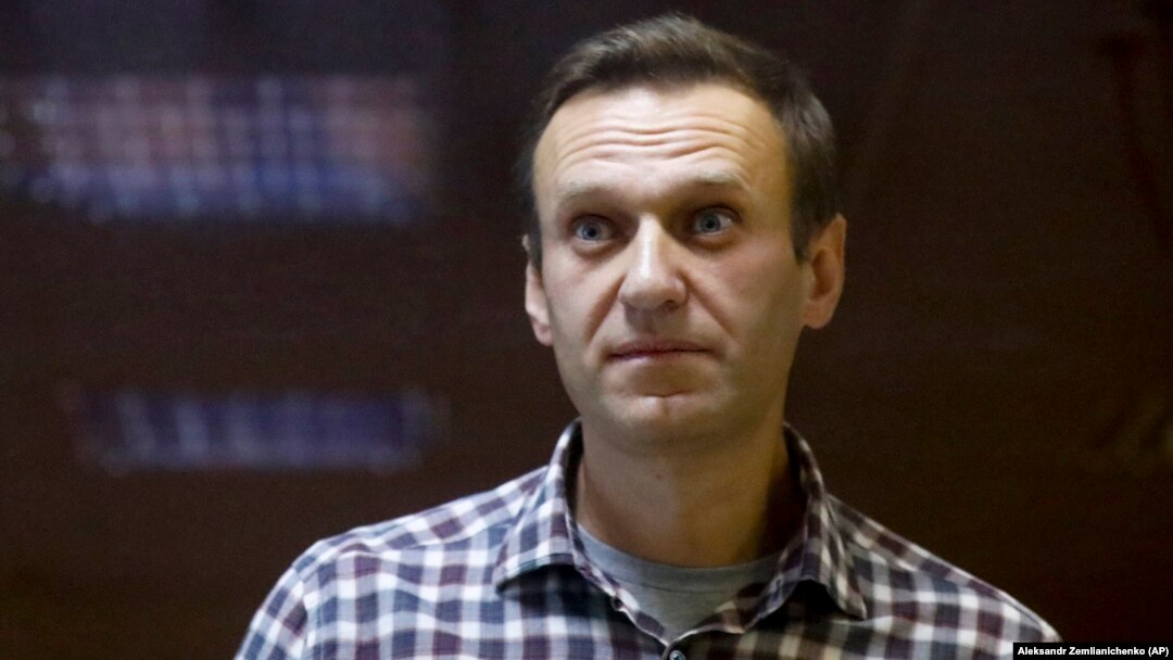 Russian opposition leader Aleksei Navalny stands in a cage in court in Moscow in February.